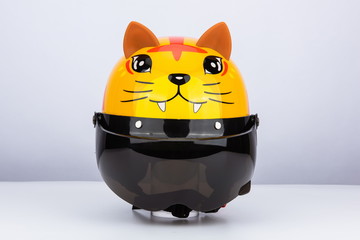 Cute tiger motorcycle helmet with wind shield and sun visor, classic helmet isolated on white...