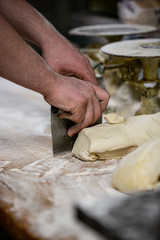 baker cutting dough