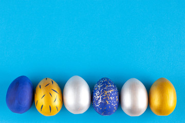 Christ is risen. Frame for text from Easter eggs in silver, gold and blue.