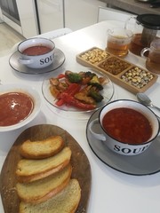 Ukrainian borscht with toast and meat on garnish.