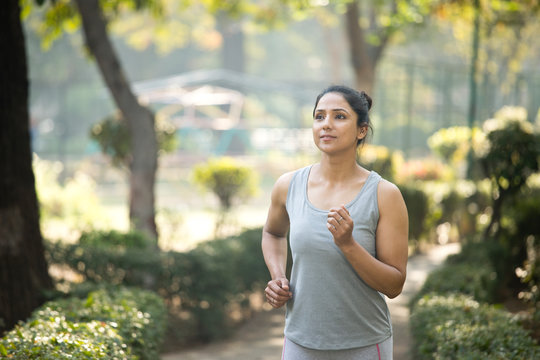 Fit sportswoman morning jogging at park outdoor