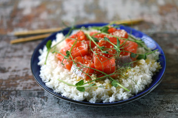 Selective focus. Poke bowl with salmon and microgreens. Healthy food.