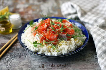 Selective focus. Poke bowl with salmon and microgreens. Healthy food.
