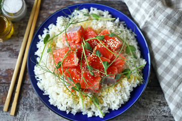 Selective focus. Poke bowl with salmon and microgreens. Healthy food.
