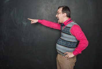 Angry screaming teacher pointing out on blackboard background