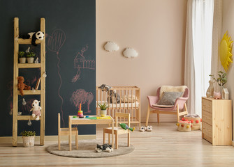 Decorative modern baby room with wooden crib bed and cabinet style.