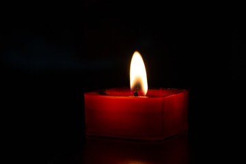 Candle on dark background