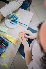 Top view of child's hands holding decorated egg