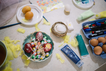 Top view of bowl with eggs and candies for Easter