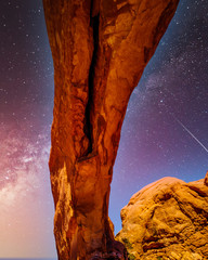 The night sky and milky way over the delicate Sandstone Arch of the North Window Arch, one of the many large Sandstone Arches in Arches National Park Utah, United States under a Starry Sky