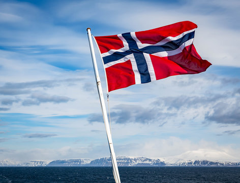 Norwegian Flag on the stern of a ship in the Artic circle