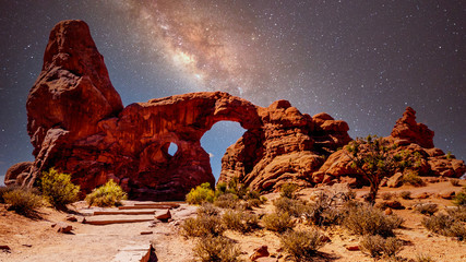 The night sky and milky way over the delicate Sandstone Arch of the Turret Arch, one of the many large Sandstone Arches in Arches National Park Utah, United States under a Starry Sky
