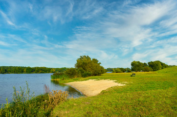 View to the Gartower Lake in Lower Saxony, Germany, under a blue sky.
