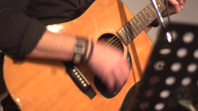 4K: Caucasian man strumming on Acoustic Guitar indoors. Stock 4k Video clip Footage