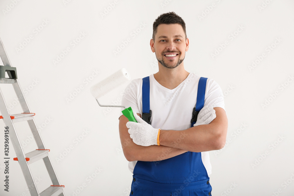 Sticker Man holding roller in empty room. Interior renovation