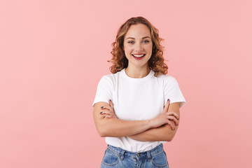 Woman posing isolated over pink wall background.
