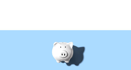 White piggy bank overhead view - flat lay