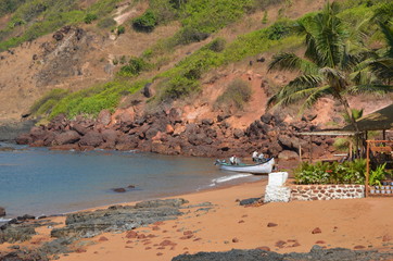 Nature in North Goa. India. Red earth, volcanic rocks and boulders. Beautiful blue sea. Vacation concept in India.