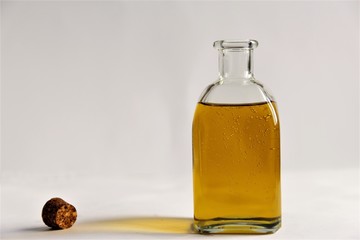 Glass bottle of olive oil open cork bottle beside the bottle photo isolate on white front view copy space 