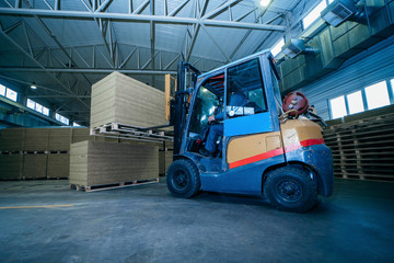 Worker driver of a forklift loader at warehouse of sandwich panels © andrew_shots