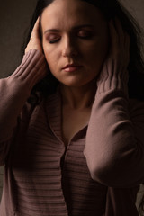 Worried woman posing in the shadows