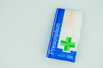 A British NHS prescription paper bag isolated on a white background - obrazy, fototapety, plakaty