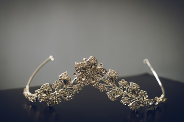 A diamond wedding tiara on a black surface