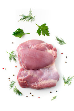 Turkey raw thigh on white background with parsley, fennel and pepper 