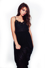 young brunette pretty woman in black dress posing on white background emotional sensual, lifestyle people concept