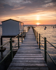 an old wooden jetty or pier at sunrise