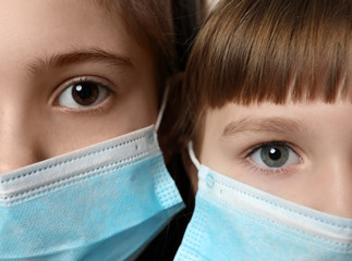 Close up of little girls wearing protective face masks