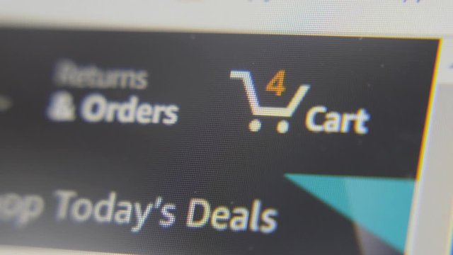 Somebody adding goods to a cart at internet shop. Online shopping