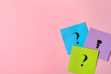 Paper cards with question marks on pink background, flat lay. Space for text