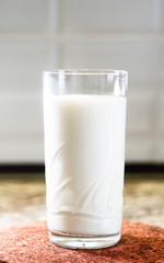 Glass of milk on a wooden stand
