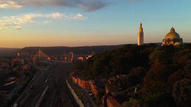 Aerial view of Li&egrave;ge-Guillemins railway station and &Eacute;glise du Sacr&eacute;-Coeur de Cointe church during sunrise