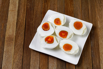 Half sliced salted egg on white plate