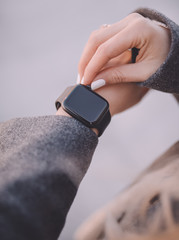 Stylish black smart watch on woman hand