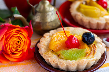 fruit and berry cream tartlet close up, bright healthy desserts