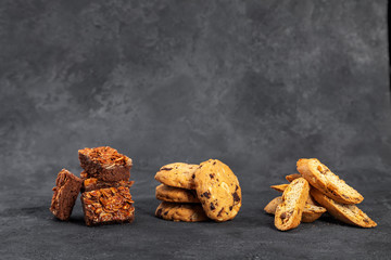 Sweet crispy nugatin biscotti cookies on dark surface