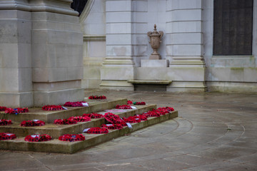 Poppy wreaths laid around a war memorial on remembrance day