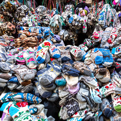 Fototapeta premium Large piles of woolen products in the clothing market.