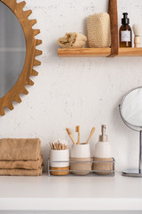 Bathroom with eco bamboo objects and cosmetic products on shelves, zero waste concept