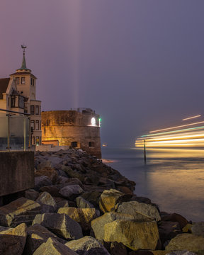 A Ferry Passing The Round Tower In Portsmouth At Night