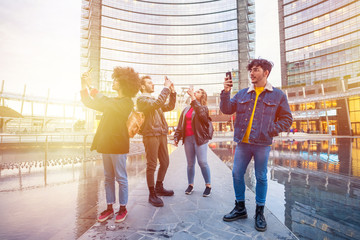 Group of friends tourist taking photos or selfie using smartphone