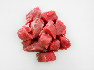 Large pieces of fresh beef on a white background. Large pieces of red meat.
