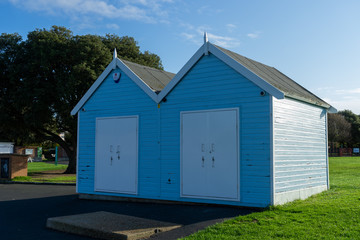 Fototapeta na wymiar Two blue and white wooden beach huts