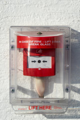 a lift and press fire alarm on the outside of a building