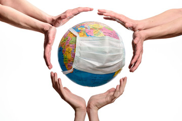 Earth globe with a protective mask. Human Epidemic Danger. Hands around the Earth globe, save or protect the planet, isolated on white background.