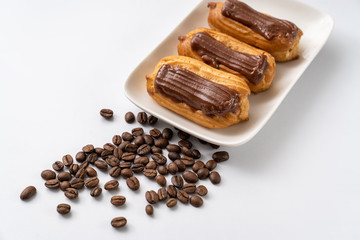 cakes chocolate icing and coffee white background