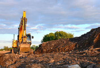 Large tracked excavator works in a gravel pit. Loading of stone and rubble for its processing at a...